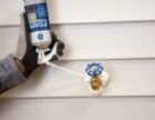 man applying sealant on a roof