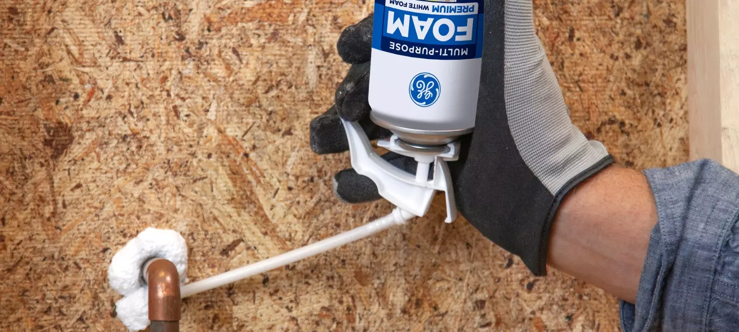 A photo of GE Multipurpose Foam being applied around a pipe