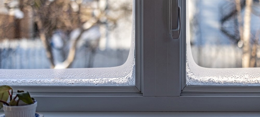 A house window with frost around the edges.