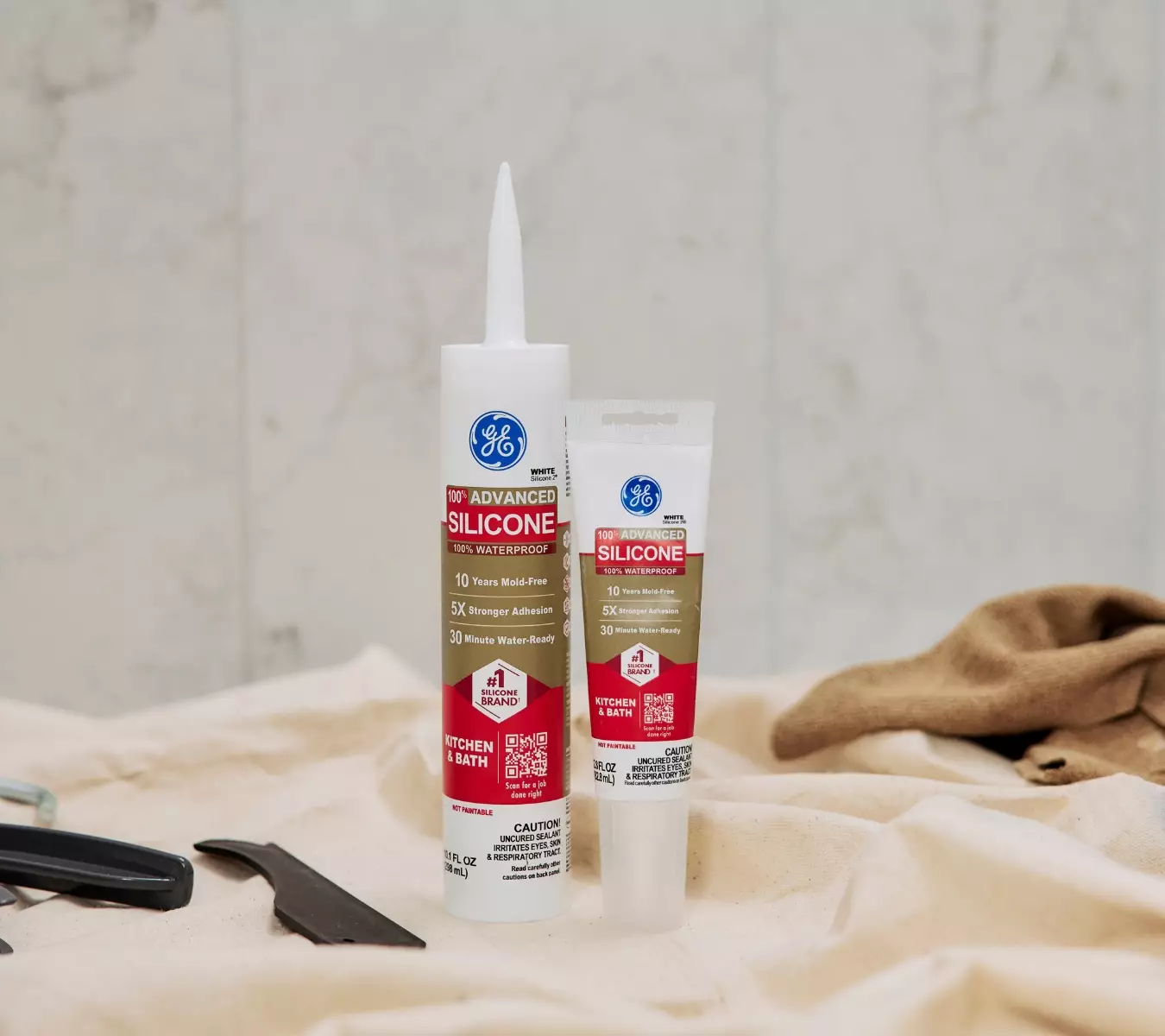 A photo of a cartridge and squeeze tube of GE Advanced Silicone Kitchen & Bath.