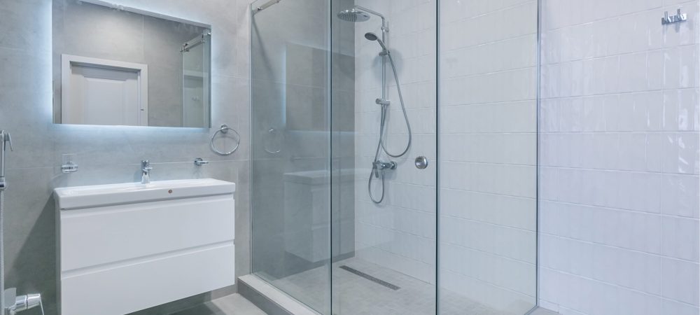 A photo of a bathroom featuring a glass‑enclosed shower.