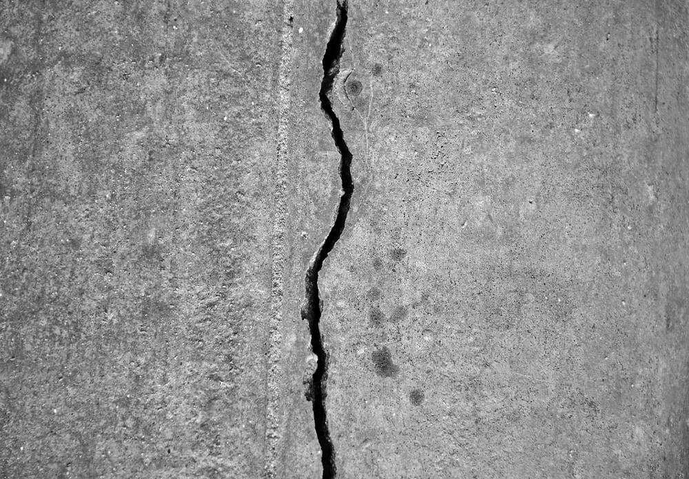 Cracked concrete and concrete gaps can capture moisture and cause further damage