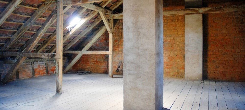 Visible gaps and cracks indicating air leaks in an attic