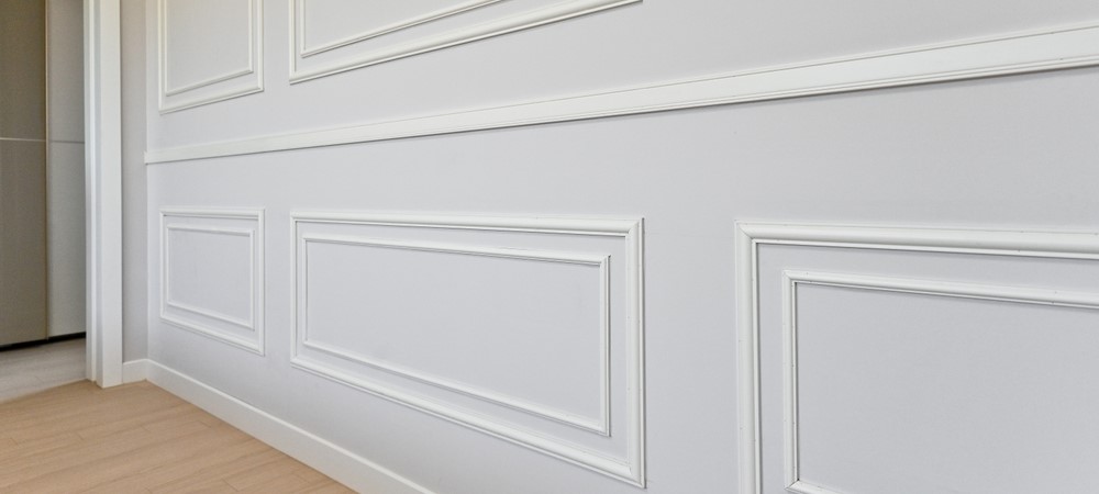 A wall decorated with wainscoting.