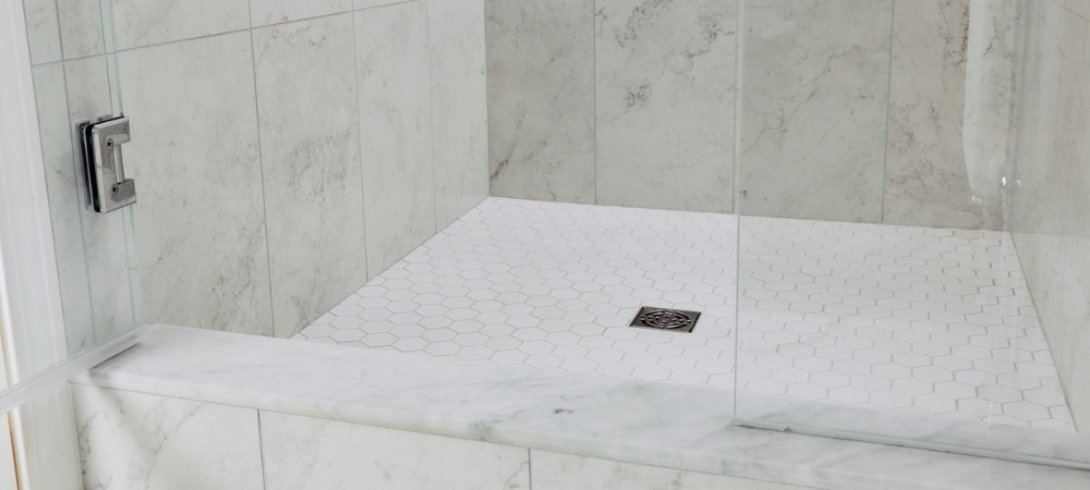 Bathroom walls with tile and grout that have been properly cleaned and sealed.