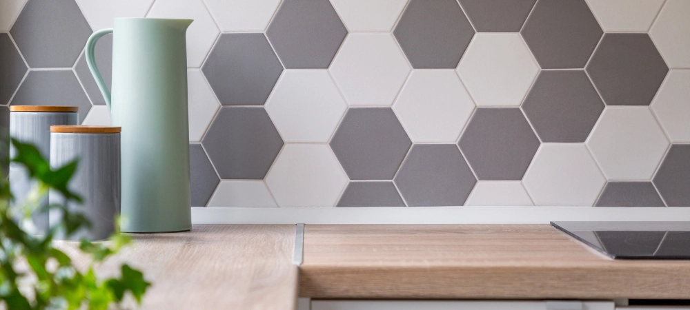 Decorative backsplash in a kitchen with white tile grout lines.