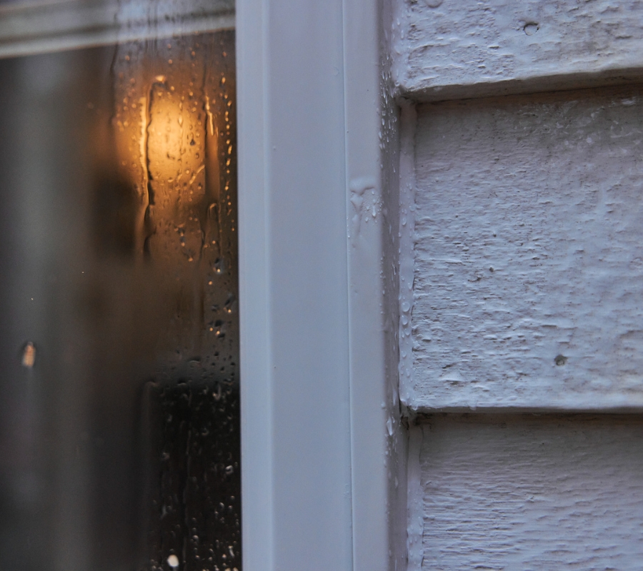 Silicone sealant applied to an exterior window frame, showing flexibility for movement and weather changes.