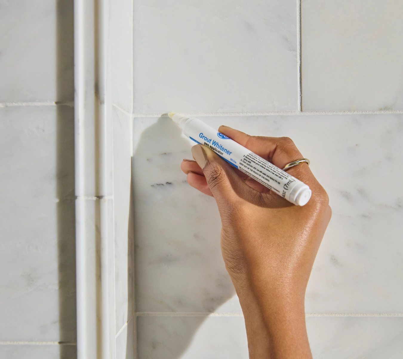A grout whitening pen brightens discolored grout.