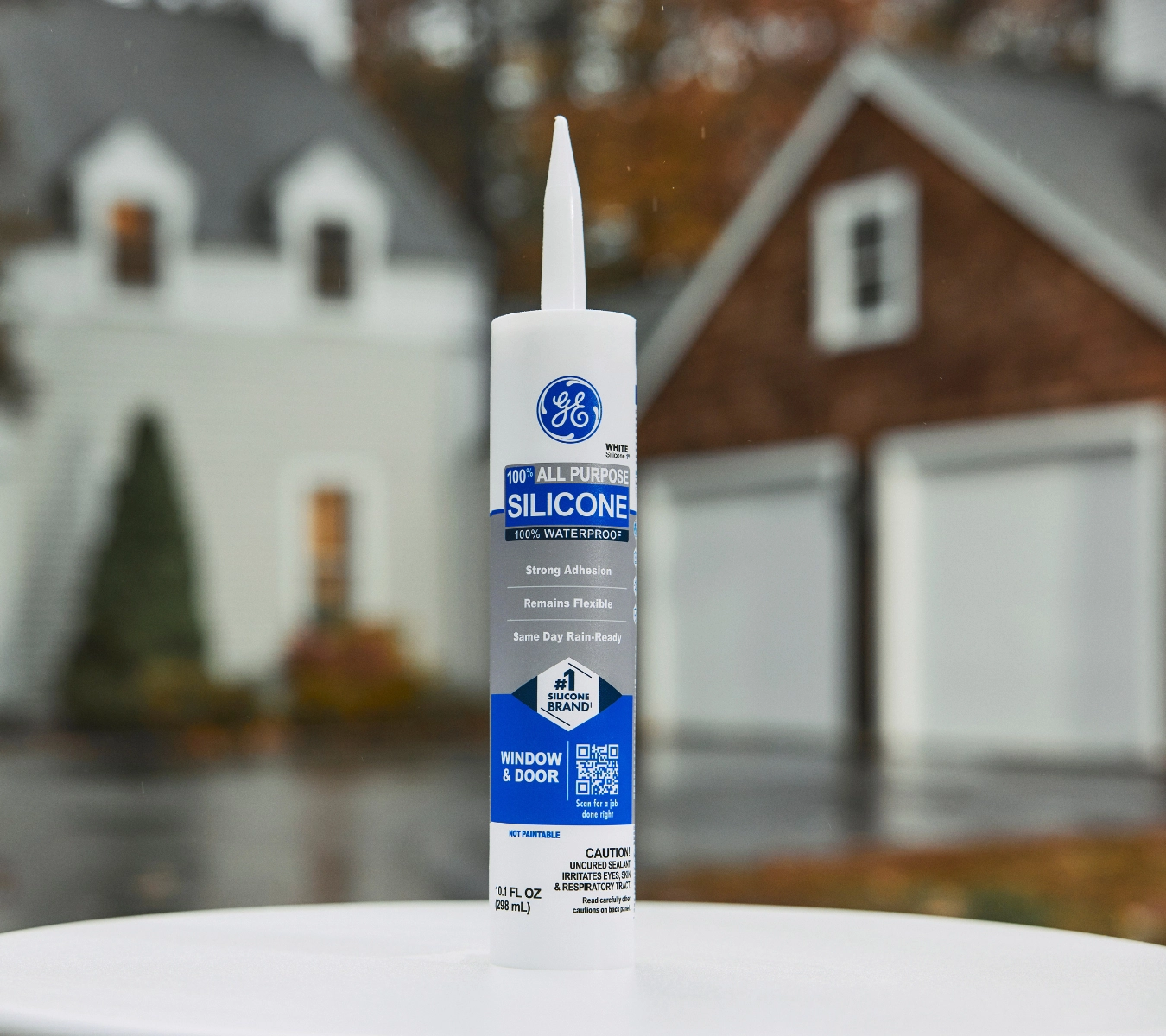 GE Silicone All Purpose cartridge displayed outside in front of a home.
