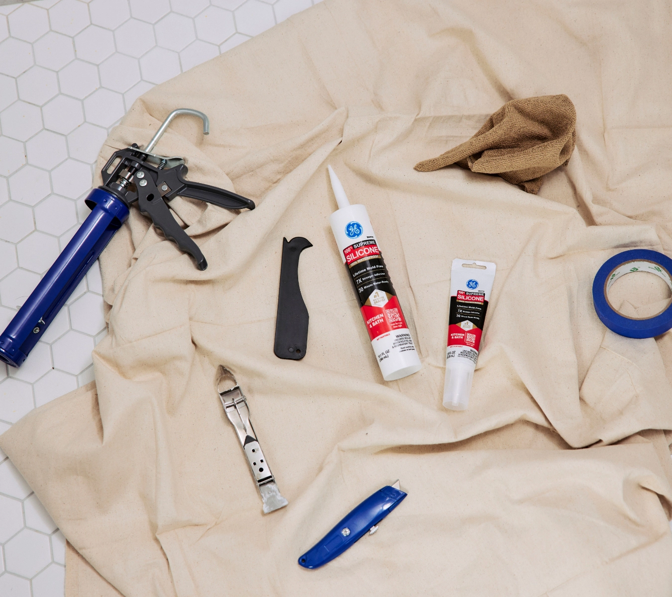 Some essential tools for recaulking a bathroom.