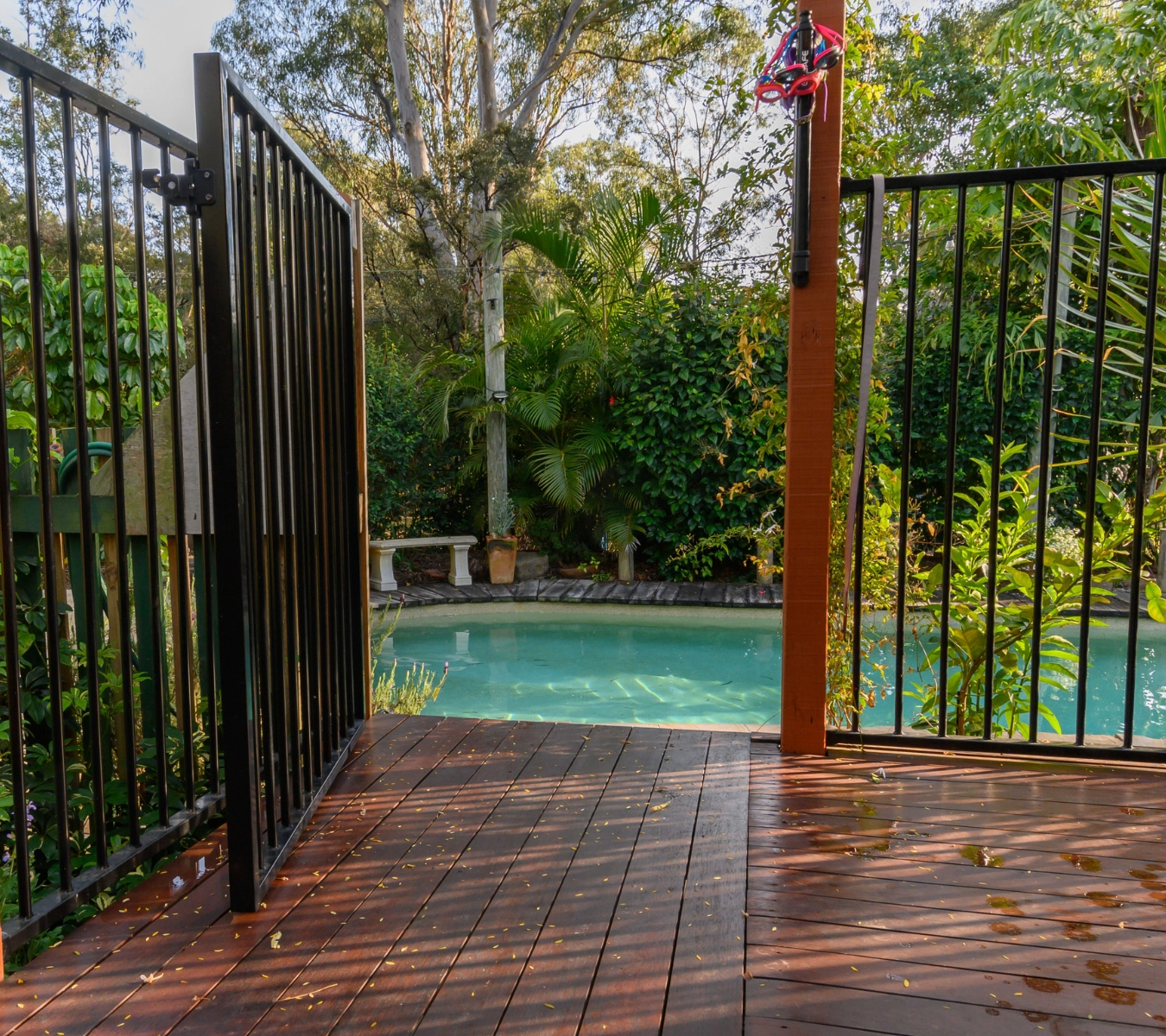 A fenced-in pool and patio area.