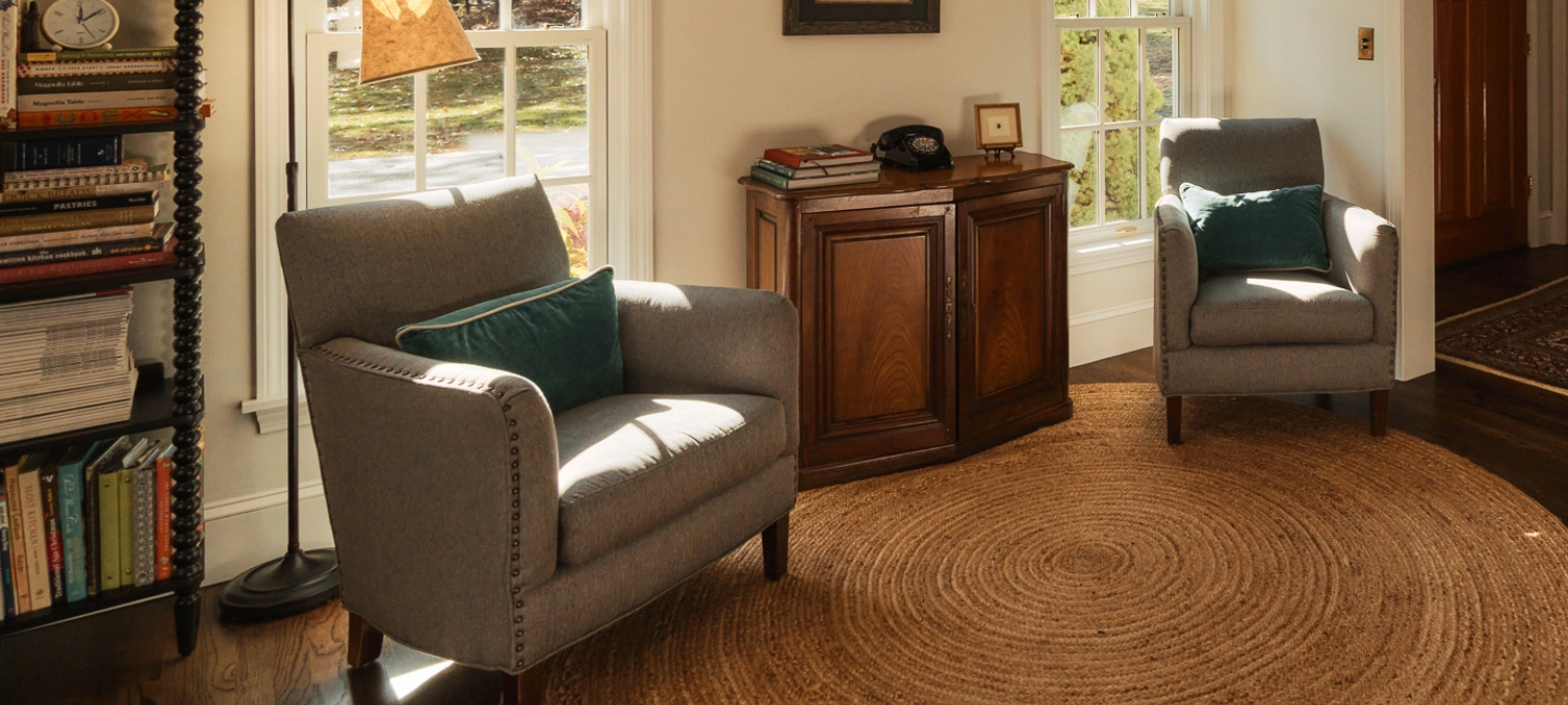 Sunlit living room with two chairs and hallway stairs, sealed with GE Colored Silicone to enhance a warm, finished space.