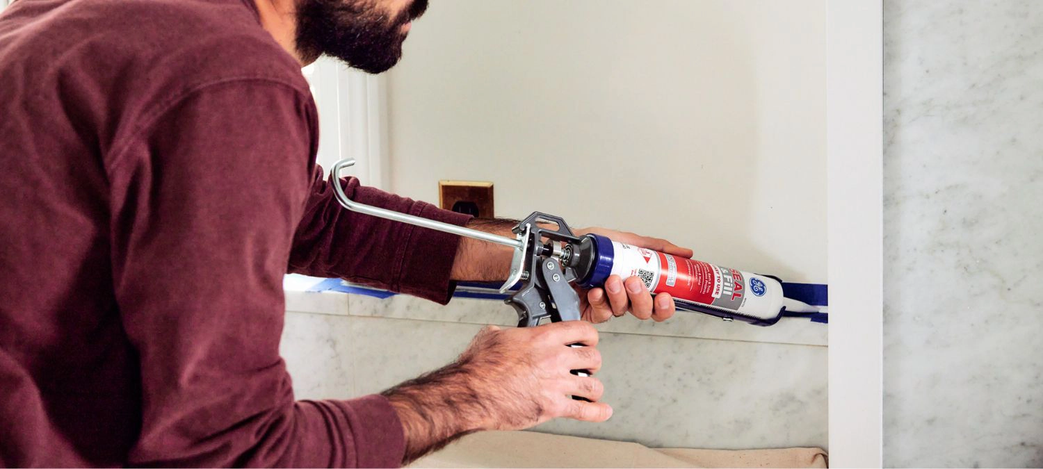 Caulking a DIY accent wall with GE Seal & Fill Multipurpose Kitchen and Bath for a seamless finish.