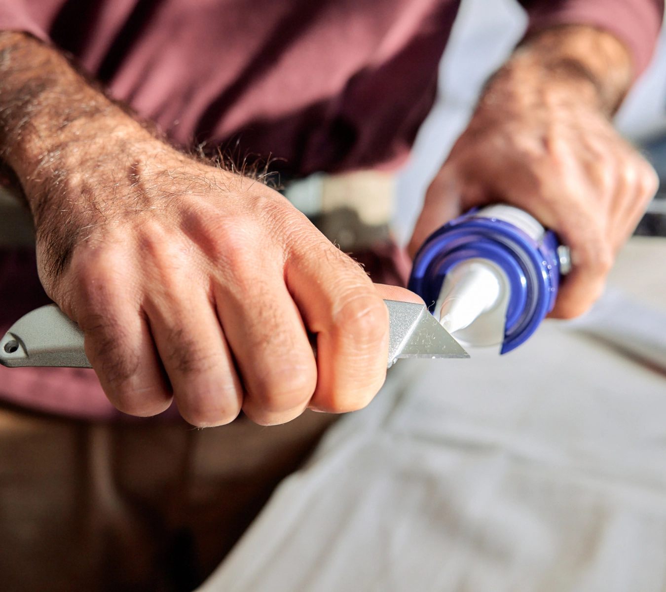A photo of a sealant tube cut at a 45-degree angle.