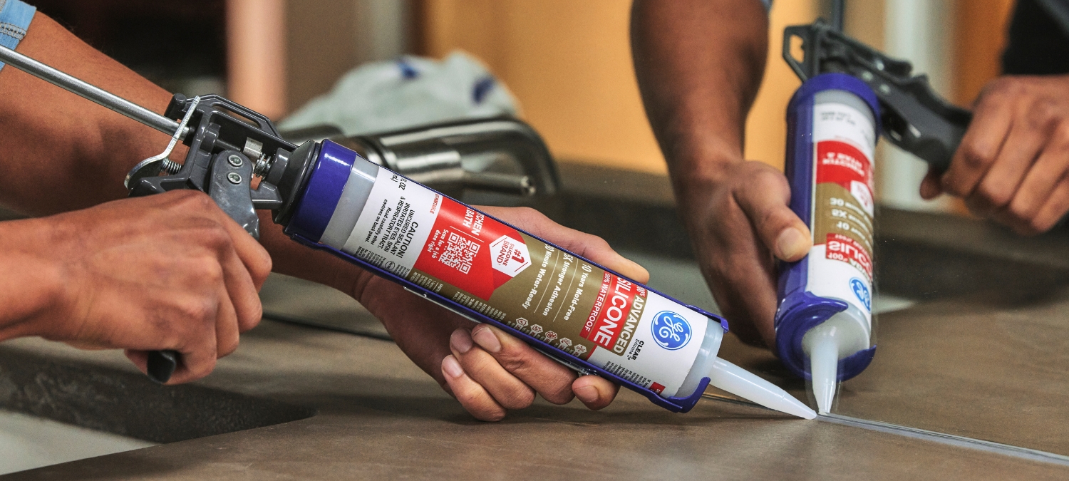 Silicone plumbing sealant on a counter-wall joint in a bathroom.