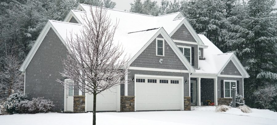 A snow-covered house that has been prepared for winter with insulating foam.
