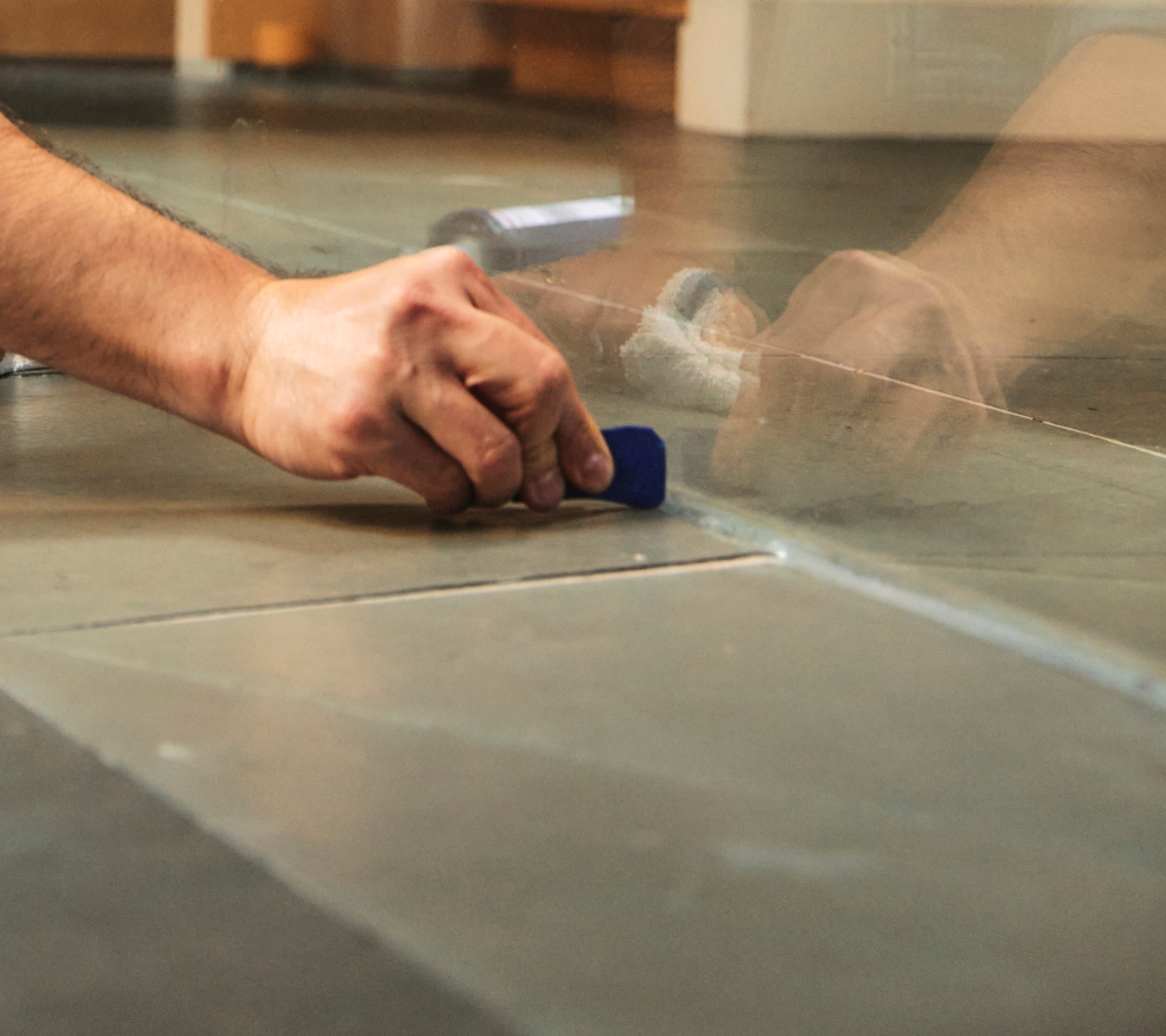 Applying and smoothing a bead with the GE Sealant Smoothing Tool along a shower tile seam for a clean, even finish.