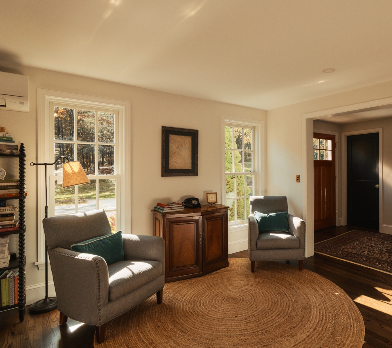 The living space inside a home with sunlight shining through the windows.