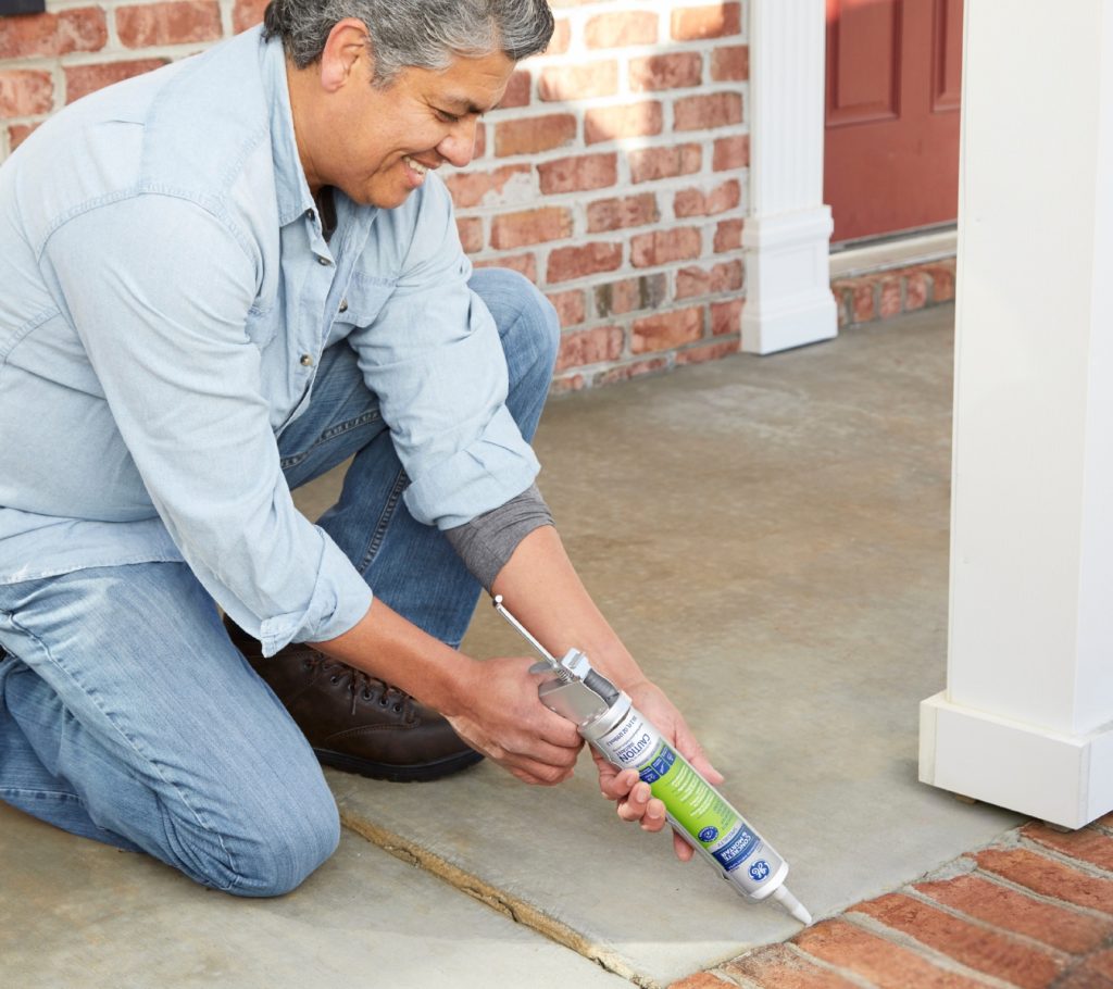 Sealing a concrete expansion joint with GE Concrete Silicone Sealant to protect steps from salt and freeze damage.