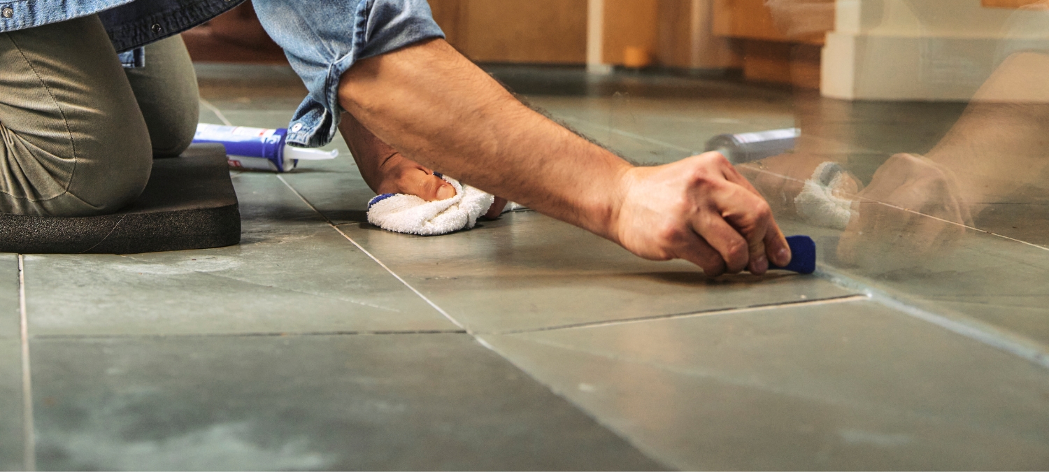 Plumber tooling a bead of Supreme Silicone Kitchen and Bath Sealant at a shower and tile joint with the GE Sealant Smoothing Tool.