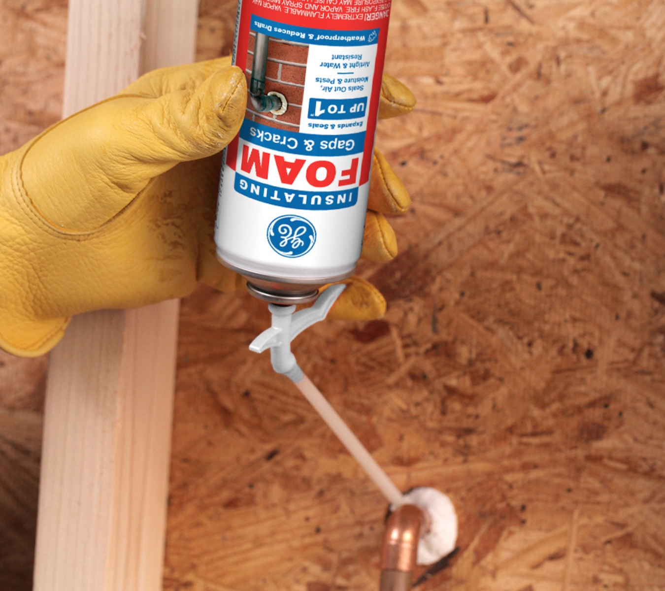 DIYer applying GE Gaps & Cracks Insulating Foam around attic penetrations to seal small gaps and reduce heat loss.