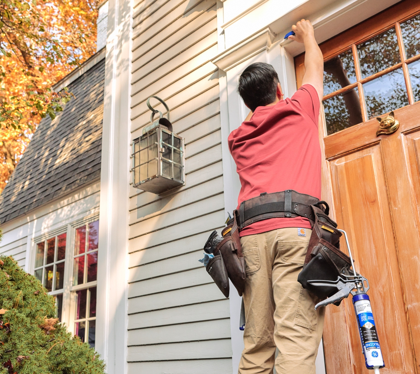 Homeowner using the GE Sealant Smoothing Tool to apply GE Supreme Silicone Window & Door sealant for a clean, airtight perimeter along a door frame.