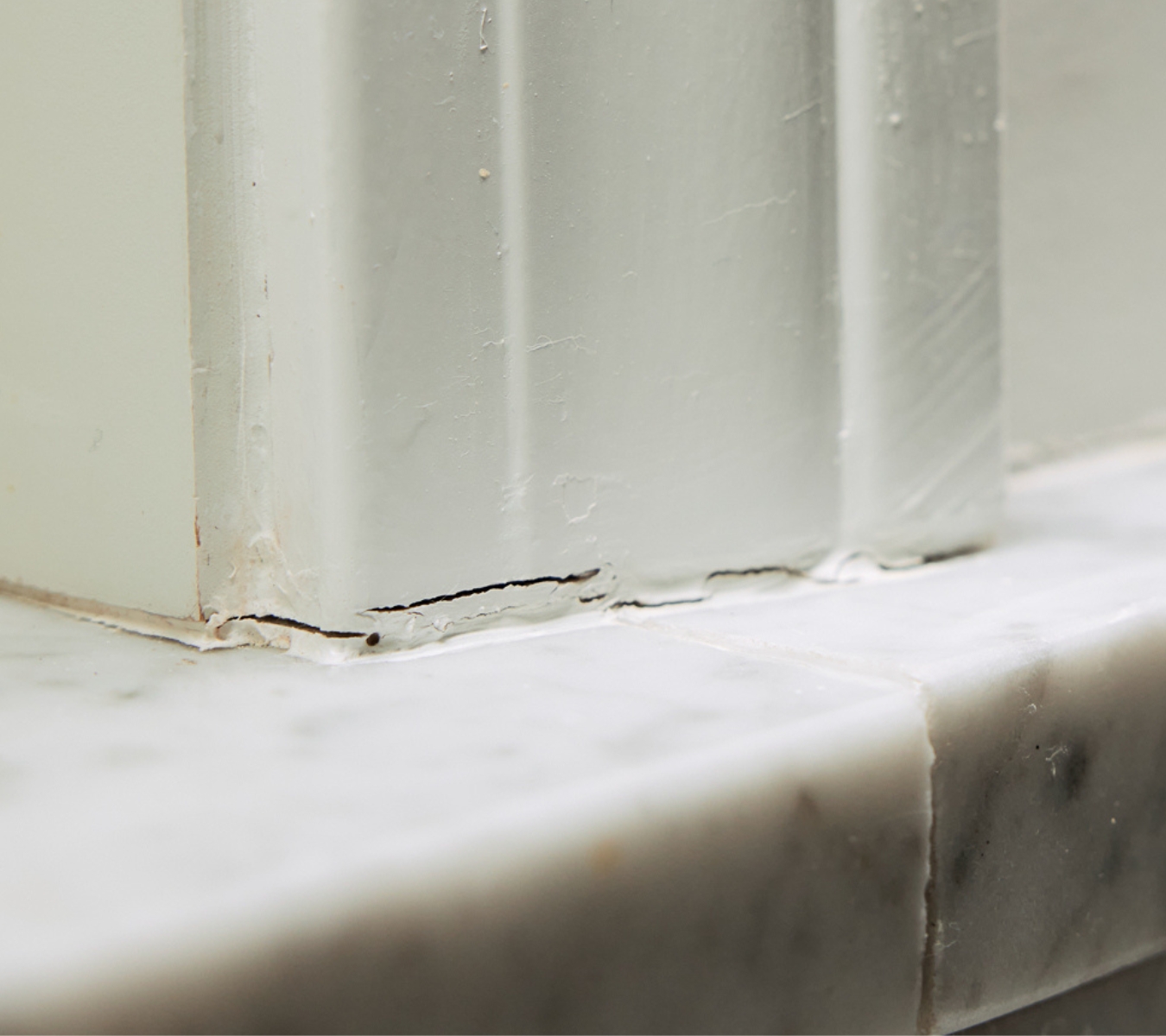 Cracked sealant near a window.