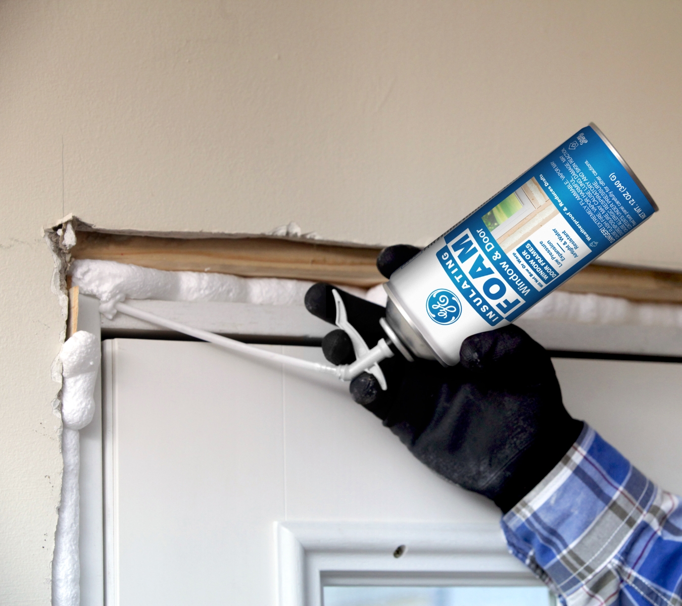 GE insulating foam applied carefully around a door frame to prevent binding.