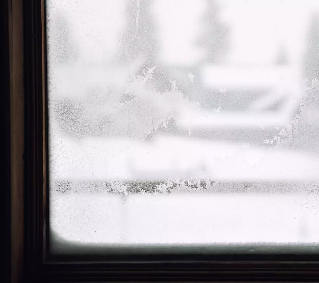 A photo of frost on a window frame.