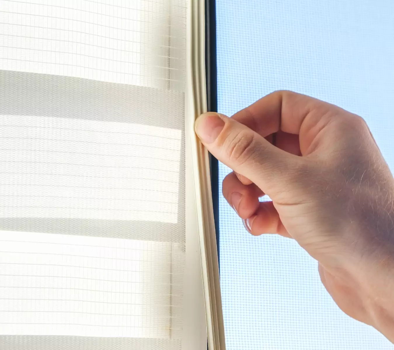 A photo of new weatherstripping installed on a window frame.