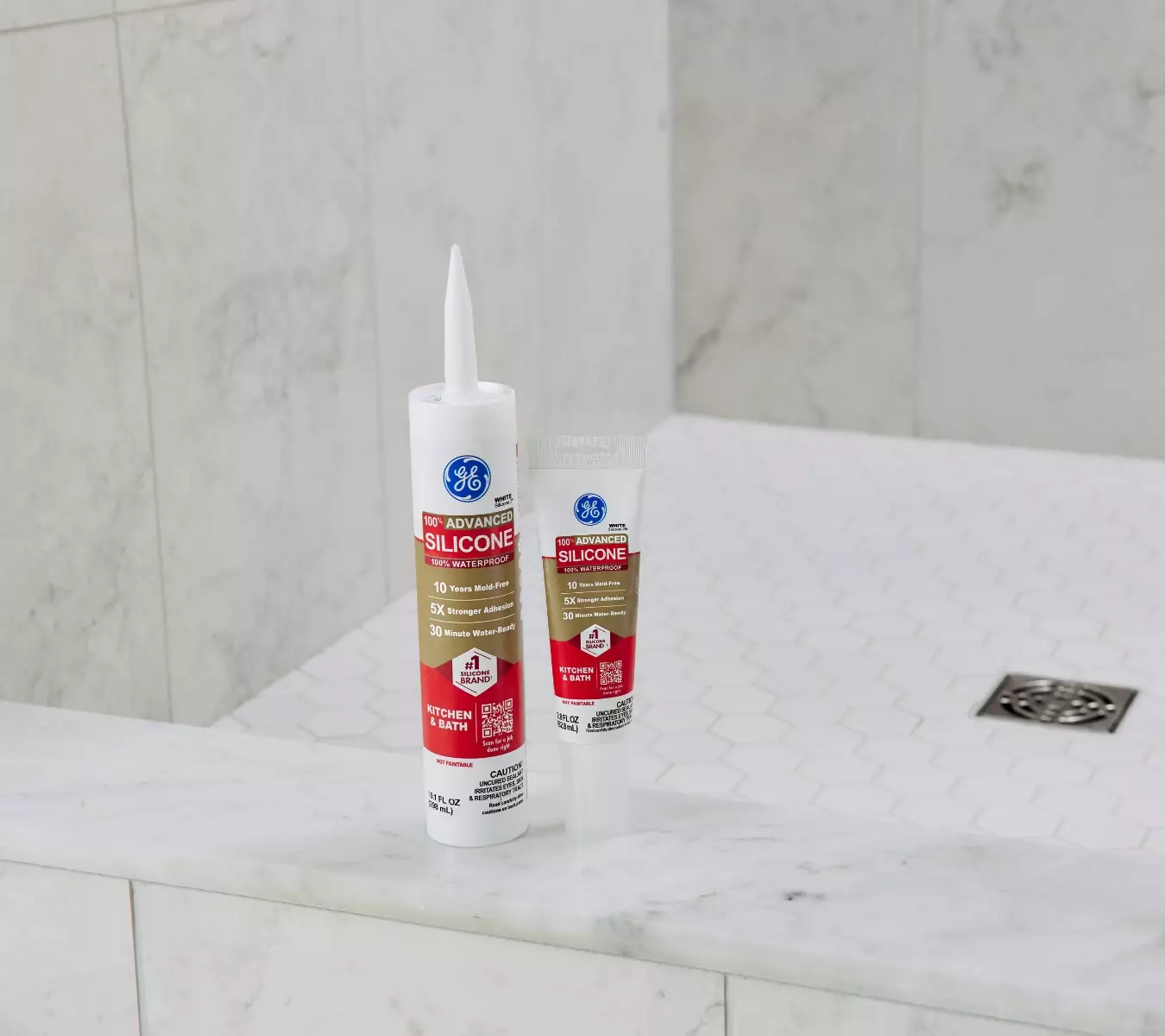 A photo of a cartridge and squeeze tube of GE Advanced Silicone Kitchen & Bath in a bathroom