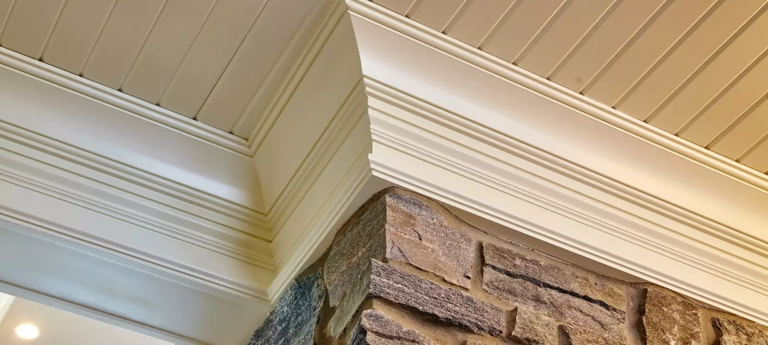 Crown molding and textured stone wall.