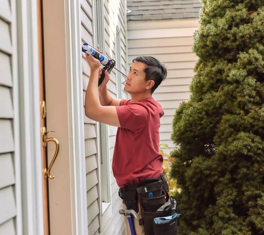 Use a photo of someone applying sealant outside. (File: GE Supreme Silicone WD_14)